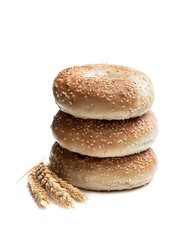 Stack of sesame seed bagels isolated on white background