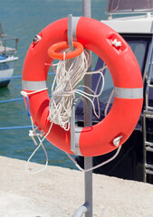 Orange lifebuoy on the dock