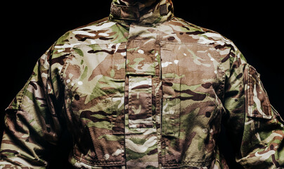 Soldier in camouflaged tunic, torso view.