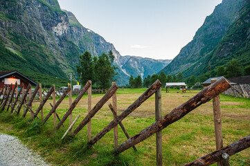 Fototapeta na wymiar A stylized fence of the ancient Vikings. Beautiful idyllic mountain landscape. Gudvangen is a popular tourist village located at the very beginning of the Neroifjord