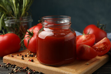 Composition with tomatoes and sauce on wooden background. Ripe vegetable