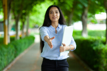 happy woman  greet by hand in street