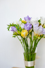 Fototapeta na wymiar Colorful freesias bouquet on white background