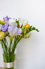 Colorful freesias bouquet on white background