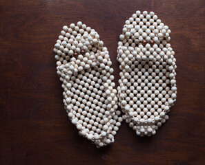 Slippers made of wooden balls. Natural physiotherapy for flat feet. Prevention against flatfoot