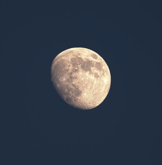 a shot of the waxing gibbous moon on a dark blue sky