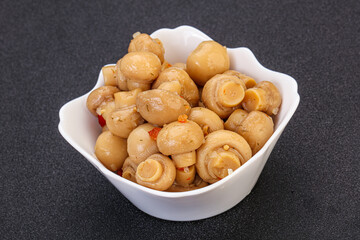 Pickled champignons in the bowl
