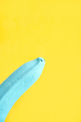 blue painted banana. part of the object. blue background