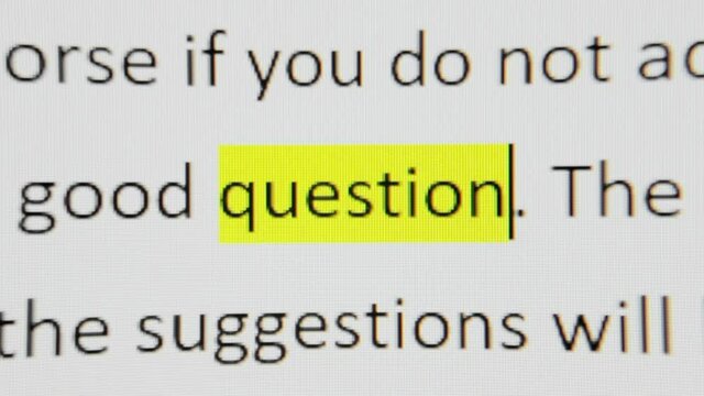 Highlighting a word from a text on a computer screen: question. Macro detail shot.
