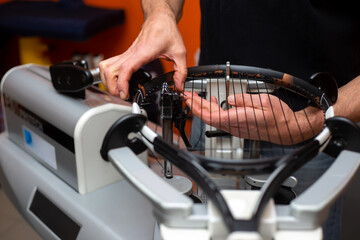 Fototapeta na wymiar Process of stringing a tennis racket in a tennis shop, sport and leisure concept