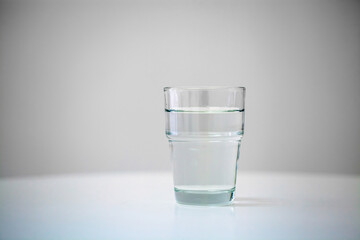 Water in a clear glass on a white table