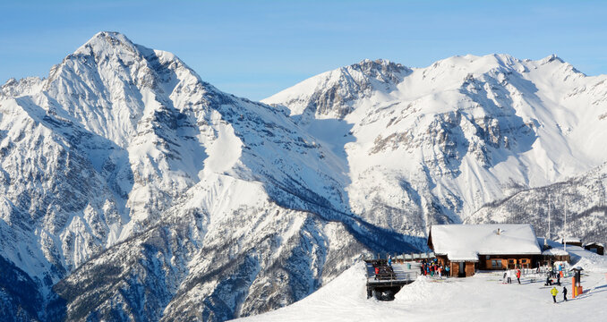 Italy / San Sicario &ndash; December 28, 2019: ski slope in San Sicario with many skiers engaged in the Via Lattea ski area.