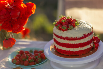 Cake red velvet with cream, decorated with strawberries.