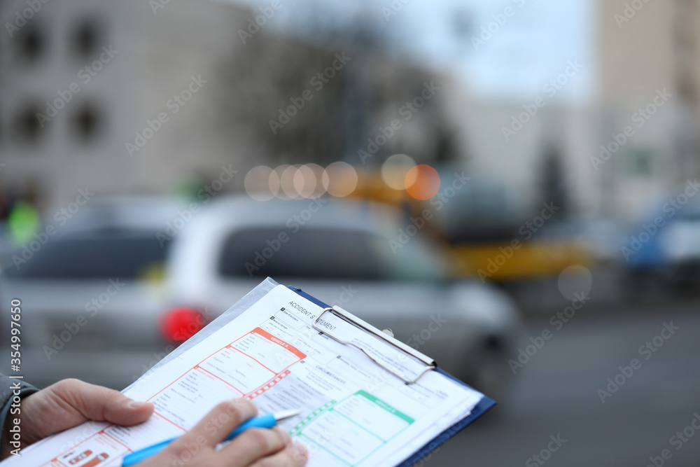 Wall mural Man on street fills out an accident statement