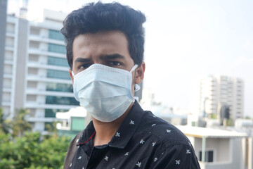 Close up of young man wearing medical mask. protection against respiratory problems.