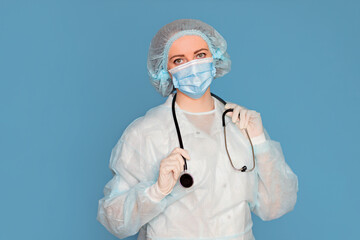 Doctor in a coat, a mask with a stethoscope in his hands. Surgeon with clinical experience in healthcare, patient care