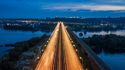 aerial night city view, luminous buildings and bridge. Drone shot.