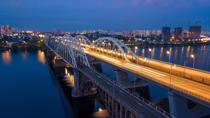 Fototapeta na wymiar aerial night city view, luminous buildings and bridge. Drone shot.