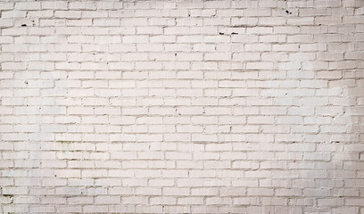Large panoramic background of white painted brick, light vignette creative copy space, horizontal aspect