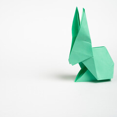 origami green hare on a white background