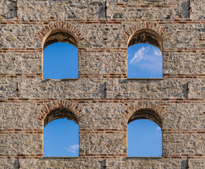 Fototapeta premium 19th century abandoned ottoman factory's brick and stone facade with arched windows during the daytime. Üsküdar, Istanbul, Turkey