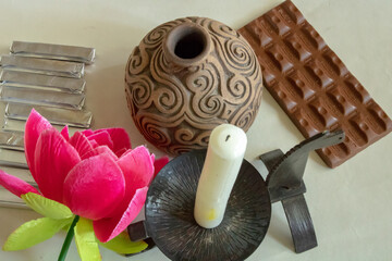 A candle in a black decorative candlestick of black color in the form of a horse and a turtle, an...