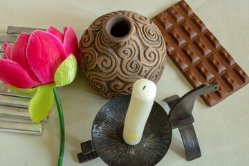 A candle in a black decorative candlestick of black color in the form of a horse and a turtle, an...