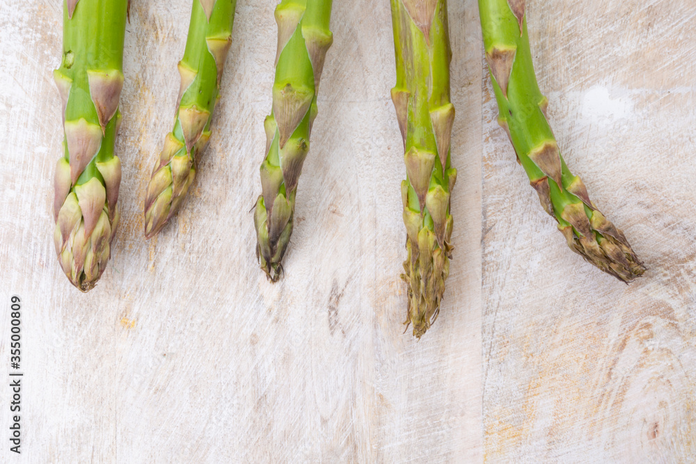 Wall mural fresh bunch of organic green asparagus spears on wooden table