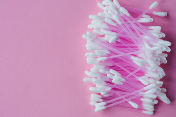 Cotton buds for medical on color background. Round container with cotton buds.