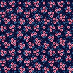 Vector seamless pattern. Pretty pattern in small flower. Small pink flowers. Dark blue background. Ditsy floral background. The elegant the template for fashion prints.