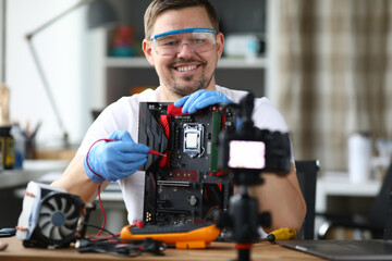 Man removes computer repair on camcorder for blog