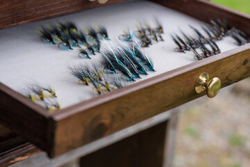 Fishing Fly and fishing rod close up in cabinet