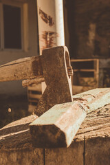 rusty ax stuck in a dry log on a sunny day