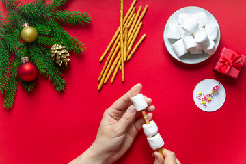 do it yourself. step by step recipe: a marshmallow snowman. step 4. on a red background...