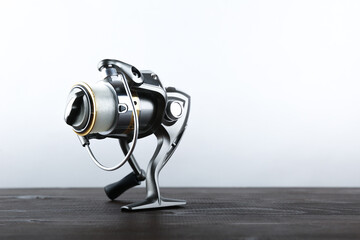 silver fishing reel front view on a white background