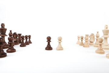 black and white pawn opposite each other on a white background. beginning of a chess game. game start concept. one on one battle