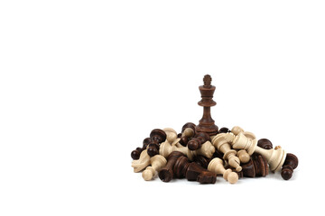 chess king on a pile of defeated pieces on white background