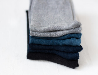 stack of men's socks on structural white background