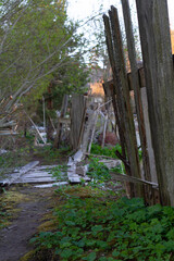 View of the village. Old fence on a blurred background.