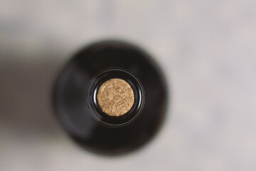 Unopened  wine bottle with an unused oak cork, top view