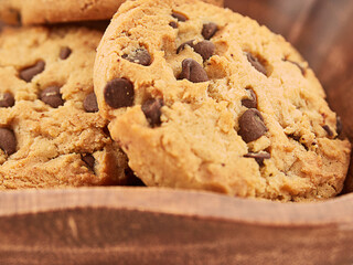 Cookies on wooden bowl on white background.