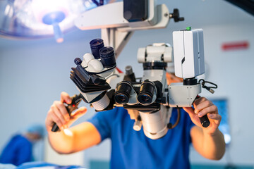 Modern microscope for operations in surgery room. Group of surgeons using operating microscope...