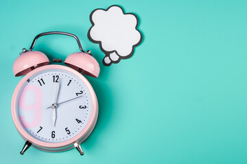 Detail close up of the old pink vintage alarm clock on colour background with free copy space.