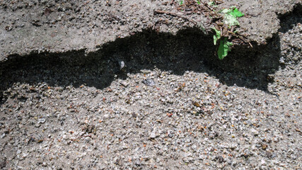 Grey gravel road, drifted away because of rain in the forest