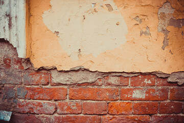 peeling wall of brick and orange plaster in the center of Moscow