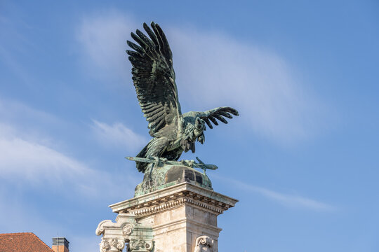 Bronze turul Bird statue on top of column at Sandor Palace on Buda Hill in Budapest winter morning