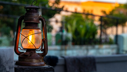 Antique Lantern, handheld lamplighter standing on a table at dusk.  © Daniel Avram