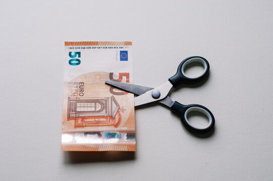 scissors that cut euro banknotes on a white background