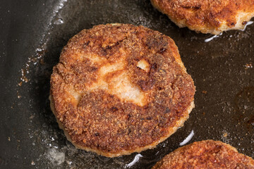 Roasted chicken cutlets in a pan. Frying process