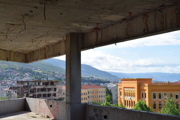 View from the Snipertower of an old damaged building and the new town hall next door, Mostar, Bosnia and Herzegovina